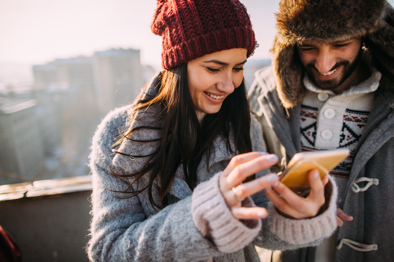 young couple looking at phone