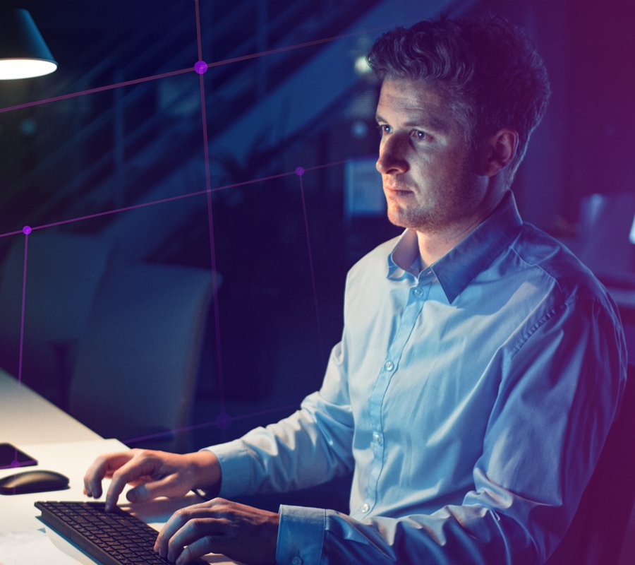 Man working on keyboard on dark background